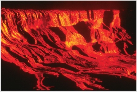 Comparing these two photographs,which eruption has lower viscosity magma?     A) The fluid cascade of lava B) The circular volcanic feature C) They could have the same viscosity. D) There is no way to tell.