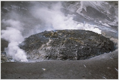 Comparing these two photographs,which eruption has lower viscosity magma?     A) The fluid cascade of lava B) The circular volcanic feature C) They could have the same viscosity. D) There is no way to tell.