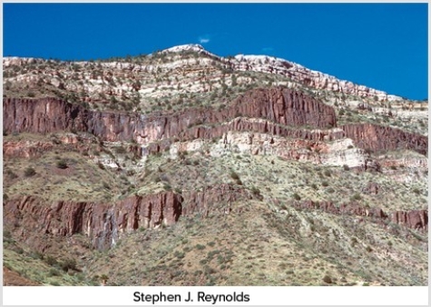 The dark igneous features shown in this photograph are   A) dikes. B) sills. C) volcanic necks. D) batholiths.