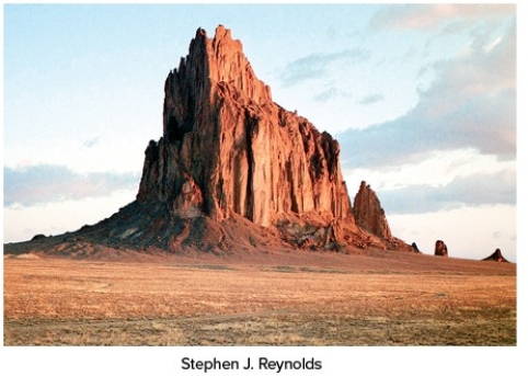 The igneous feature shown in this photograph is a   A) dike. B) sill. C) volcanic neck. D) batholith.