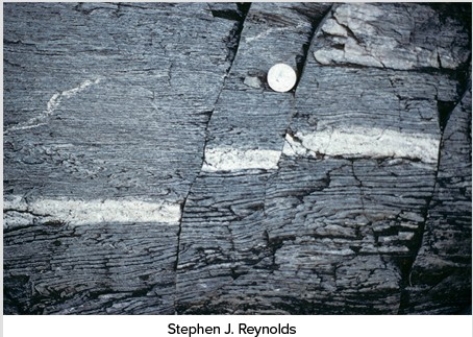 What type of deformation is shown in this photograph?   A) Displacement B) Rotation C) Internal strain of the rock D) Columnar joints