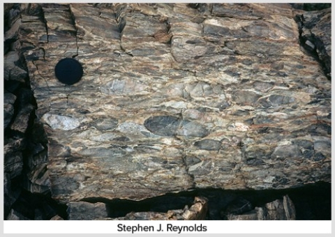 What type of deformation is shown in this photograph?   A) Displacement B) Rotation C) Internal strain of the rock D) Columnar joints