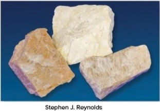 The very common mineral shown in this photograph is commonly a pink- to cream-colored mineral with wavy,light-colored lines.What mineral is it?   A) Garnet B) Quartz C) Biotite D) Muscovite E) Feldspar