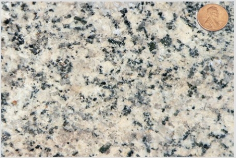 Which of the following rock photographs depicts a felsic igneous rock? A)    B)    C)    D)   