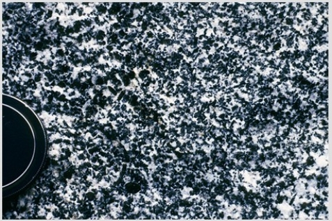 Which of the following photographs depicts an igneous rock where the magma cooled slowly at first and then had fast cooling? A)    B)    C)    D)   
