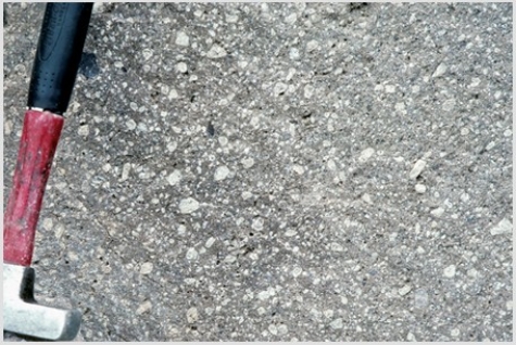 Which of the following photographs depicts an igneous rock where the magma cooled slowly at first and then had fast cooling? A)    B)    C)    D)   