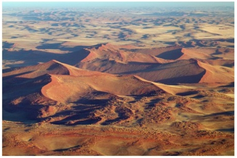 The sand dunes shown in this photograph   A) are isolated and have well-defined crescent shapes. B) formed in a wet climate based on their shape. C) are part of a complex dune field. D) are loess deposits. E) are inactive because they have been eroded by running water.