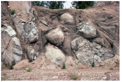 Why does weathering of granite bedrock produce rounded shapes?   A) the rounded shapes are pillows formed at depth in the granitic magma B) weathering removes corners and edges,as in spheroidal weathering C) burrowing animals eat away parts of the granite D) roots rub against the edges of the granite