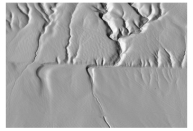 What type of feature is shown in this image?   A) a fold in metamorphic rocks B) a scarp along a strike-slip fault C) erosion of gently tilted layers D) a hogback