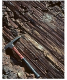 What type of feature is shown in this photograph?   A) anticline B) columnar joints C) scratch marks along a fault D) folded metamorphic rocks E) all of these