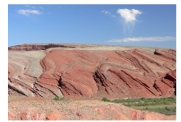 What types of features are shown in this photograph of unmetamorphosed sedimentary rocks?   A) erosion of very tightly folded gneiss B) erosion along joints C) erosion of strong and weak layers D) erosion of a series of fault scarps