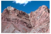 What type of feature is shown in this photograph of unmetamorphosed sedimentary rocks?   A) a fault B) tight folds formed at moderate to high temperatures C) cleavage D) columnar joints