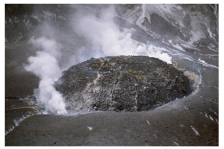 Comparing these two photographs,which eruption has lower viscosity magma?     A) the fluid cascade of lava B) the circular volcanic feature C) they could have the same viscosity D) there is no way to tell