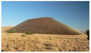 What types of rocks would be most common in the small volcano in this photograph?   A) scoria and other vesicular basalt B) basalt mostly formed in lava flows C) felsic and intermediate lava flows D) welded tuff and tephra E) none of these