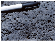 Which of the following photographs depicts an igneous rock where the magma cooled slowly at first and then had fast cooling? A)    B)    C)    D)   