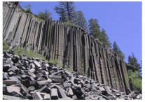 The igneous rocks shown in this photograph are forming:   A) a dike B) an irregular pluton C) a volcanic neck D) columnar joints