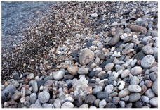 Which of the following surface environments is the most likely site for deposits in this photograph?   A) steep mountain front B) glacier C) sand dunes D) beach E) lake