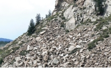 Which of the following surface environments is the most likely site for deposits in this photograph?   A)  steep mountain front B)  river channel C)  sand dunes D)  beach E)  lake