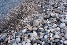 Which of the following surface environments is the most likely site for deposits in this photograph?   A)  steep mountain front B)  glacier C)  sand dunes D)  beach E)  lake