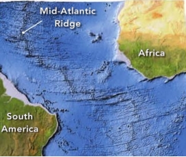 The image shows the Mid-Atlantic Ridge, a submarine volcanic mountain belt that is a key location in the process of:   A)  seafloor spreading B)  land bridges C)  continental drift D)  South Atlantic drift