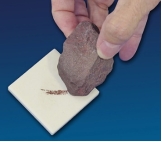 What mineral test is shown in this photograph?   A)  scratch test B)  effervescence C)  streak D)  magnetism E)  specific gravity