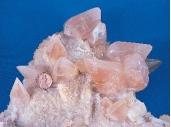 What does the shape of these crystals indicate about the environment in which they formed?   A)  They formed at great depth and under very high pressures. B)  They formed from cold water that was moving rapidly through the rocks. C)  They formed into a space filled with water rather than solid rock. D)  They grew during an explosive volcanic eruption.