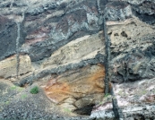 The vertical igneous feature shown in this photograph is a:   A)  dike B)  sill C)  volcanic neck D)  batholith