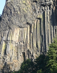Columnar joints, like the ones shown in the photograph, are formed:   A)  when hot but solid igneous rock contracts B)  when hot liquid igneous rock contracts C)  when hot but solid igneous rock expands D)  when hot liquid igneous rock expands