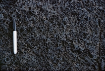 What type of basaltic feature is shown in this photograph?   A)  vesicles B)  volcanic bomb C)  aa lava flow D)  pahoehoe lava flow E)  pyroclastic flow