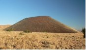 What types of rocks would be most common in the small volcano in this photograph?   A)  scoria and other vesicular basalt B)  basalt mostly formed in lava flows C)  felsic and intermediate lava flows D)  welded tuff and tephra E)  none of these