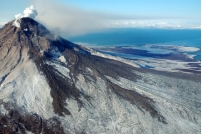 What type of material likely composes this volcano?   A)  felsic to intermediate lava flows B)  pyroclastic flows C)  volcanic mudflows and landslides D)  all of these