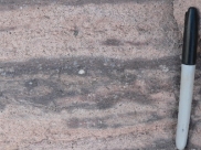 What type of eruption formed this flow-banded rhyolite?   A)  a viscous lava flow B)  a pyroclastic column C)  a pyroclastic flow D)  a lava that broke apart while it flowed E)  a lava fountain
