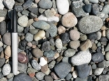 What is the best explanation for the shape of these clasts?   A)  they are composed of relatively soft, soluble materials B)  they accumulated on a steep slope C)  they have been moved by the wind and rounded by blowing sand in sand dunes D)  they have been transported a significant distance