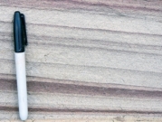 This sandstone consists of well-sorted sand grains, was deposited on land, and locally contains large cross beds. What is the most likely environment in which it formed?   A)  sand dunes B)  river C)  beach next to a sea D)  deep-water turbidity currents
