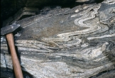Under what conditions was this rock likely deformed?   A)  relatively shallow B)  brittle conditions C)  conditions that favored fracturing D)  hot and deep conditions