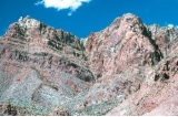 What type of feature is present in the notch in the center of the photograph?   A)  fault B)  joint C)  columnar joint D)  slate
