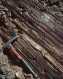What type of feature is shown in this photograph?   A)  anticline B)  columnar joints C)  scratch marks along a fault D)  folded metamorphic rocks E)  all of these