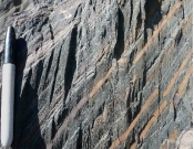 This rock is not shiny and has a well-developed cleavage that cuts across bedding. What is the correct name for this rock?   A)  schist B)  quartzite C)  slate D)  gneiss