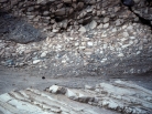 This photograph shows an upper unit with fragments and a lower unit with tilted layers. Which of the following statements is true?   A)  the upper unit is younger because it is on top B)  the upper unit is younger because it contains pieces of the underlying unit C)  the lower unit is older because it was tilted and eroded before deposition of the upper unit D)  all of these
