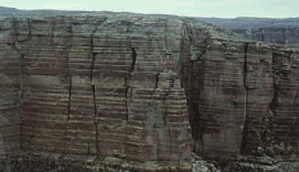 Where are the oldest rocks in the column of sedimentary rocks shown in the diagram?   A)  At the bottom B)  At the top C)  In the middle