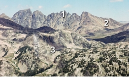 Which numbered features)  on this photograph are consistent with the presence of glaciers sometime in the past?   A)  1, an arête B)  2, U-shaped valley C)  3, tarn D)  all of these