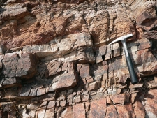 The layer of quartzite in this photograph would mostly weather by:   A)  dissolution B)  hydrolysis C)  physical weathering D)  spontaneous combustion