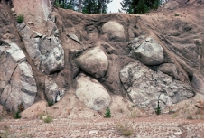Why does weathering of granite bedrock produce rounded shapes?   A)  the rounded shapes are pillows formed at depth in the granitic magma B)  weathering removes corners and edges, as in spheroidal weathering C)  burrowing animals eat away parts of the granite D)  roots rub against the edges of the granite