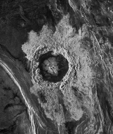 This radar image of a crater on Venus shows:   A)  an area of light-colored, smooth rocks around the crater B)  that the crater contains dark-colored, rough rocks C)  a central area of dark-colored hematite surrounded by light-colored feldspar D)  the roughness of the materials, but does not indicate whether the rocks are light or dark colored
