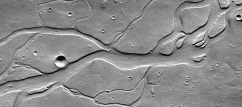 What do these channels indicate about past events on Mars?   A)  there were explosive volcanic eruptions B)  strong winds eroded into a series of volcanic layers C)  the surface once had running water that eroded and deposited sediment D)  glaciers once covered the entire planet