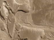 What does this curved feature, which contains a point bar, indicate about past events on Mars?   A)  there were explosive volcanic eruptions B)  strong winds eroded into a series of volcanic layers C)  the surface once had running water that eroded and deposited sediment D)  glaciers once covered the entire planet
