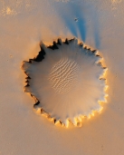 The presence of dunes in the middle Victoria Crater on Mars indicates that:   A)  Mars has an atmosphere B)  volcanic eruptions produced abundant sand C)  glaciers once covered most of Mars D)  seas once covered this area, leaving behind the dunes