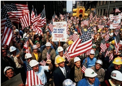 What can be inferred about the  hard hats  shown demonstrating in this image?   A)  They were antiwar student protestors. B)  They were pro-war student protestors. C)  They were pro-war union members. D)  They were antiwar union members.