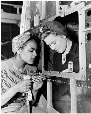 According to the photo titled  Riveting Rosies,  in what wartime industry were women especially important?   A)  The construction of aircrafts B)  The shipping of rations to soldiers abroad C)  The design of the atomic bomb D)  The production of uniforms