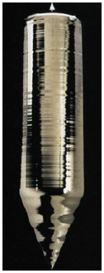 Silicon is one of the Group IV semiconductors and has an energy gap of 1.12 eV.Generally only metals have highly shiny surface,yet as shown in the figure,silicon appears to reflect like a metal.This is because   A) silicon is a good semiconductor with a well defined energy gap. B) visible light has energies in the range 2-3 eV which is much larger than the energy gap allowing electrons to be promoted from the valence band to the conduction band. C) the surface of silicon is smooth making it reflect like a metal. D) silicon can be grown in very high purity.It is the impurities that make a semiconductor dull looking. E) None of these is correct.